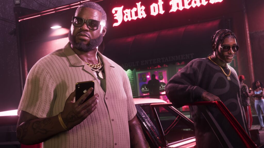 GTA 6 two men wearing sunglasses and gold chains get out of a car